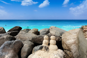 Two sandy snowman in Caribbean.