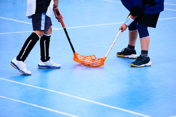 Obraz premium Floorball child boy player with stick and ball. Children playing florball sport