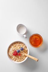 Breakfast. Cereals with fruits, milk and honey. Top view. Copy space.