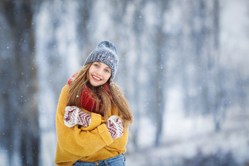 Winter young woman portrait. Beauty Joyful Model Girl laughing and having fun in winter park. Beautiful young female outdoors, Enjoying nature, wintertime