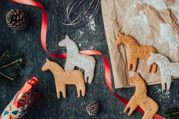 Rustic and messy composition of dala horse cookies - obrazy, fototapety, plakaty
