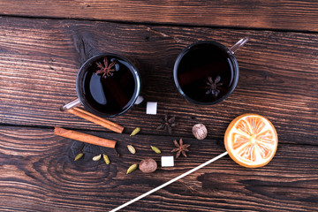 Glasses of mulled wine, Cooking with spices, cardamom, cinnamon on kitchen table background top view