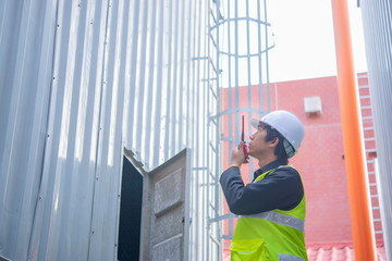 Asian Maintenance engineer at the waste water management system of a huge factory,maintenance checking technical data of heating system equipment,Thailand people