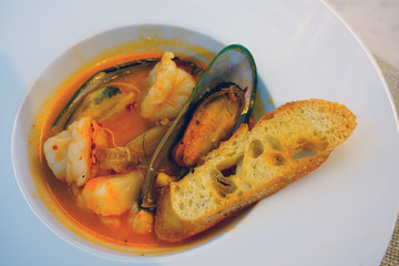 Dish of cioppino seafood stew with mussels and bread crouton 