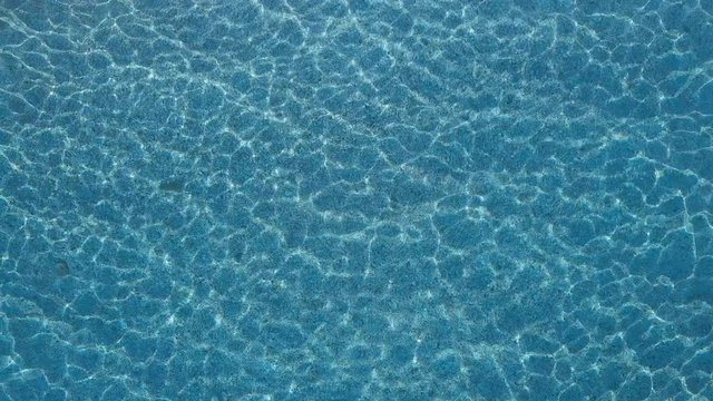 Clear water of the blue sea light reflections. Aerial footage