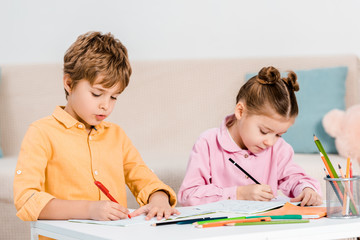 beautiful little children writing and studying together