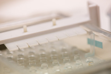 Macro detail of a agarose slab mold and well forming plastic comb for use in gel electrophoresis. Shallow focus. Genetic therapy and medicine concept.