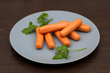 sausages and parsley on a gray plate