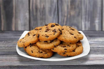 Plate of chocolate chip cookies isolated on white background
