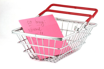 Shopping basket and shopping list isolated on white background