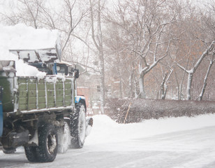 Fototapeta na wymiar Wheel loader machine removing snow in winter.