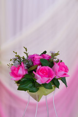 Bouquet of roses on White and pink cloth blur background. Romantic love design.