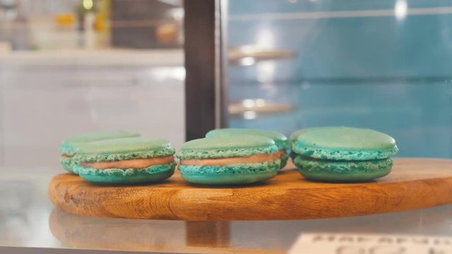 Blue macaroons behind the shop window. Close up