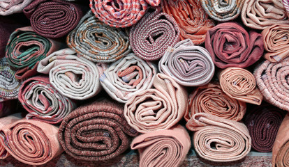 rolls of precious fabric on the shelf