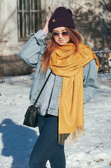 Fototapeta na wymiar Street style Fashion portrait pretty young woman in trendy casual clothes, smiling, in sun glasses. Sunny winter day, city lifestyle