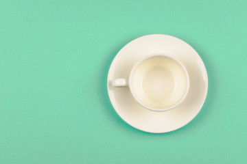 Empty cup on green background