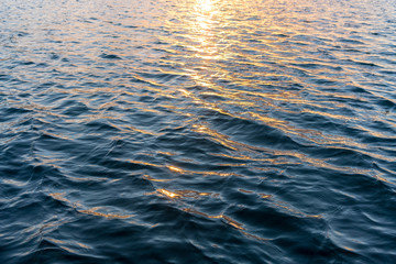 Blue waves and orange sun light reflection texture