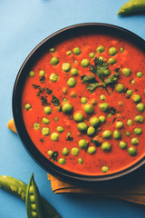 Green Peas curry / Matar masala served in a bowl over moody background. selective focus