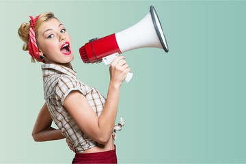 Young beautiful blonde woman with loudspeaker