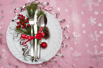 Christmas table place setting with christmas pine branches,ribbon and bow. Christmas holidays background.