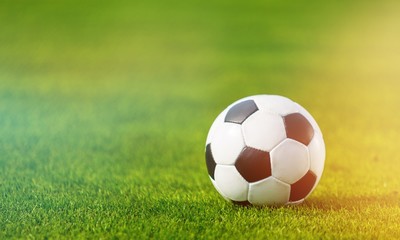 Close view of green football field with soccer ball