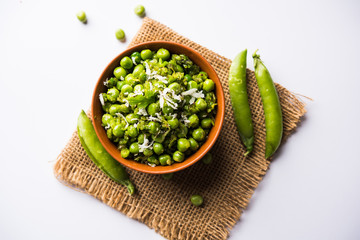 Green peas dry recipe or matar ki sookhi sabji, served in a serving pan or terracotta bowl. Selective focus