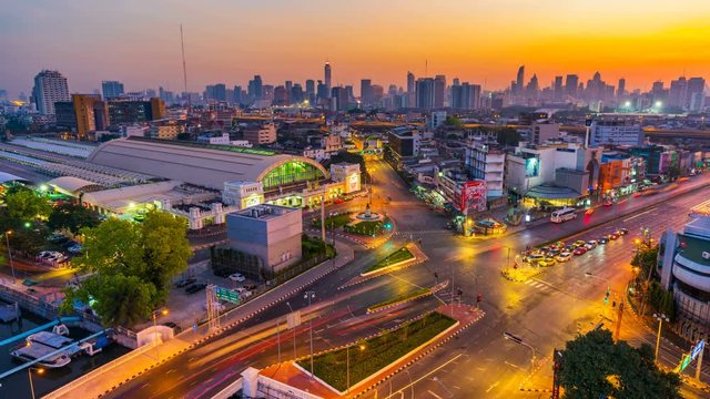 Night to day time lapse of traffic at Hua Lamphong intersection and Hua Lamphong railway station in Bangkok, Thailand