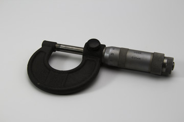 old soviet micrometer on white background close up