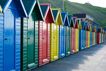 f brightly painted beach huts at Whitby on the Yorkshire coast