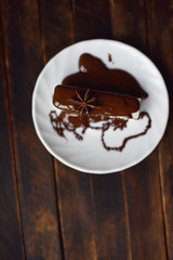 pastille in chocolate icing on a white plate
