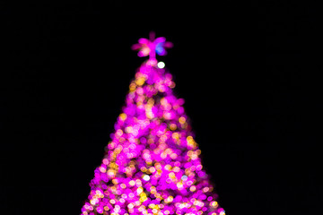 Colorful light Abstract bokeh of Christmas tree and happy new year background.