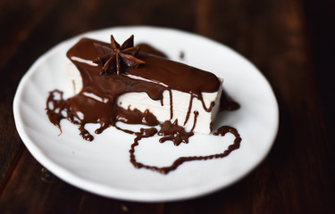 pastille in chocolate icing on a white plate
