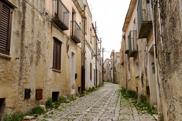 Fototapeta na wymiar Typical narrow stone street in the medieval historical center of Erice, Sicily