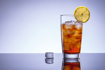 Coke cocktail with ice and lemon, alcohol bar