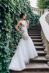 Bride in a white dress. Bride on the steps.
