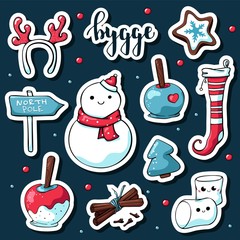 Cute doodle hygge stickers. Vector hand drawn stickers with hygge lettering and cozy things: snowman, deer antlers, marshmallows, apple in caramel, stocking, north pole sign, cinnamon, christmas tree.