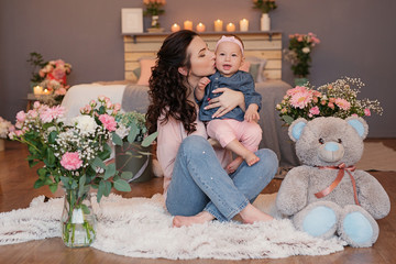 family photo session of mom and daughter on the bed with candles and flowers