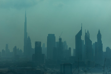 Fototapeta na wymiar Dubai, UAE - October, 2018. Beautiful skyline of Dubai surrounded by sand dust at day light