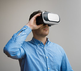 Handsome man in virtual reality goggles. Space for your text.