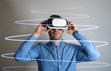 Handsome man in virtual reality goggles. Space for your text.