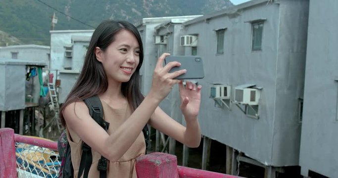 Woman take photo on cellphone in Tai O village
