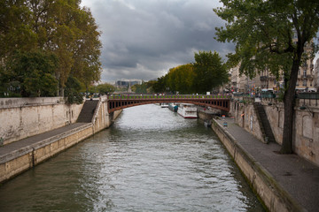 The view from the banks of the Seine River in Paris, France on a cloudy day.