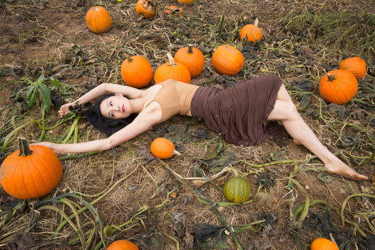 Adult Woman Dancing In A Connecticut Pumpkin Patch In Autumn.