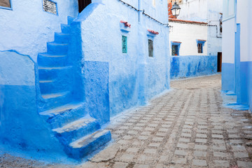 blue walls and stairs on the street in blue city Chefchaouen in Morocco