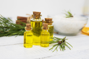 body oil in small jars on a background of pine branches
