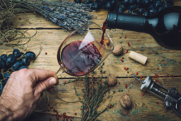 Wine maker pouring red wine (bio) for tasting. Red wine tasting (bio wine) in a wine glass with...