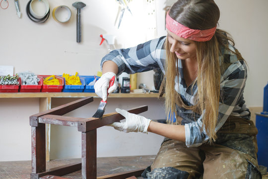 woman restoring furniture