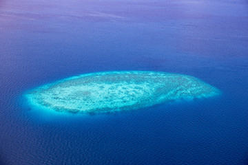 Aerial of the beautiful Maldives, looking down at some stunning islands and atolls