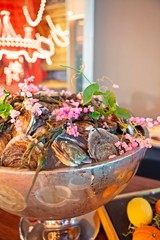 Tasty fresh oysters with flower decorate. Raw oysters are packed with nutrition, high in calcium, potassium, magnesium, vitamin and mineral. Flavor are sweet and refreshing. Believed to be aphrodisiac
