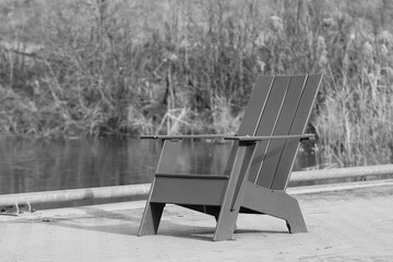 Empty Chair beside a Frozen pond